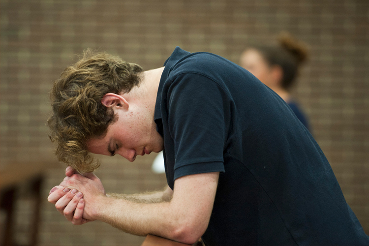 A young man in prayer (Photo: CBCEW)